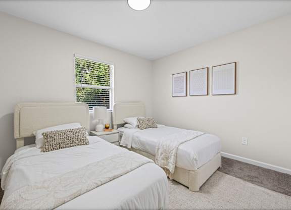 Two white bedrooms with a window and pictures on the wall.