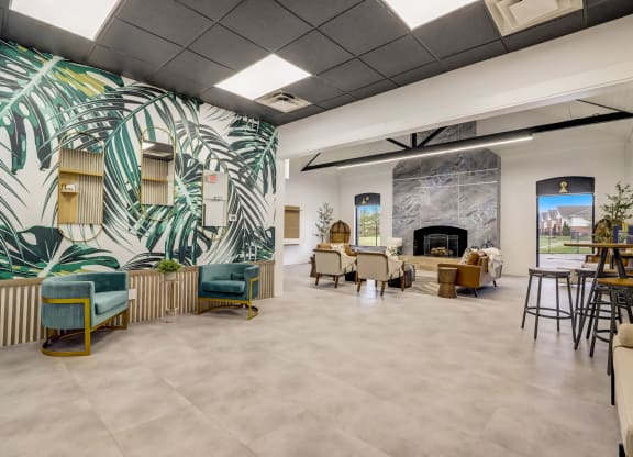 the lobby of a building with tables and chairs and a fireplace