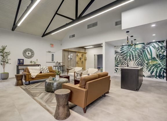 a lobby with couches and chairs and a clock on the wall