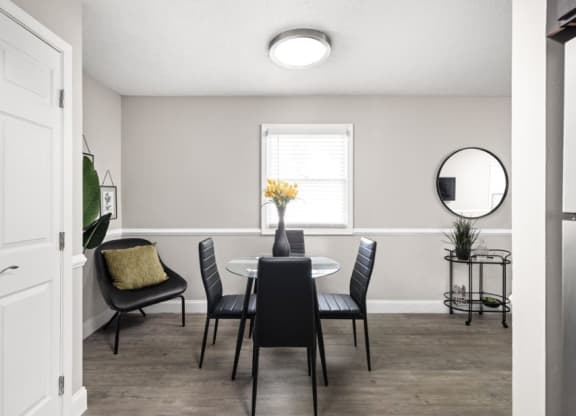 a dining room with a table and chairs