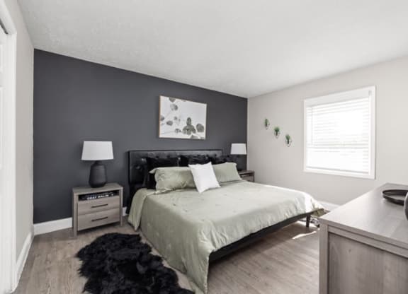 a bedroom with a bed and a dresser