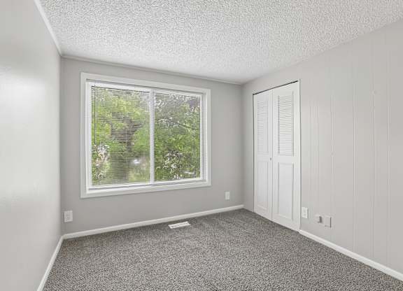 A room with a window and a door.