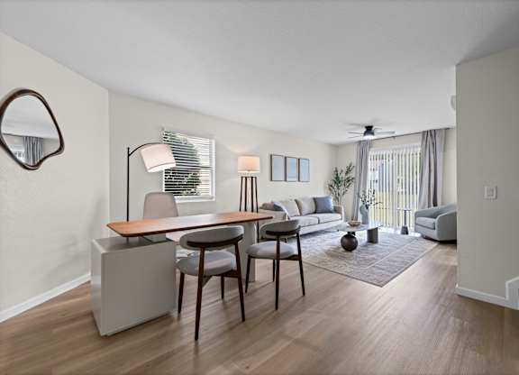 A living room with a dining table and chairs.