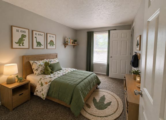 A bedroom with a bed, nightstand, and pictures on the wall.