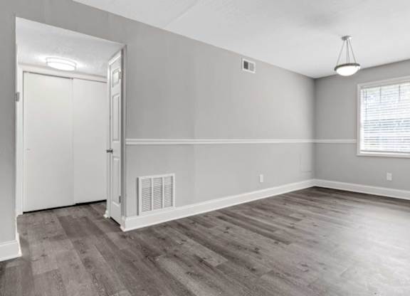 A room with a door, window, and a light fixture.
