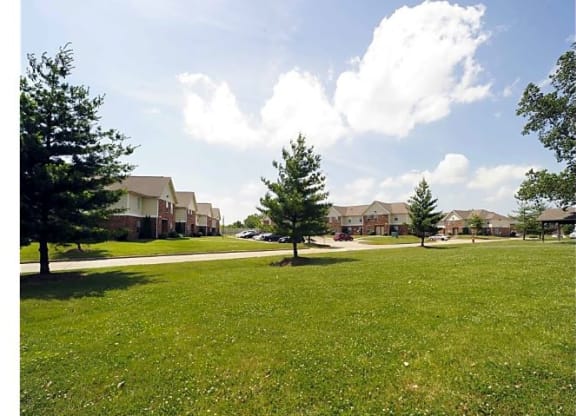 Spacious grass areas with several trees at Woodhaven Park in Indianapolis, IN. 