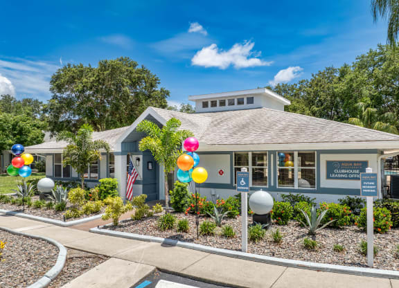 a blue building with balloons in front of it at Aqua Bay Apartments in Naples, FL 34116