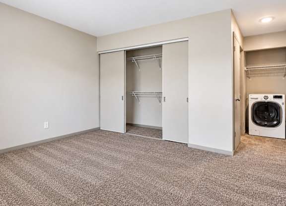A room with a laundry area and a washer and dryer.