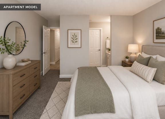 A well-lit bedroom with a large bed and a wooden dresser.