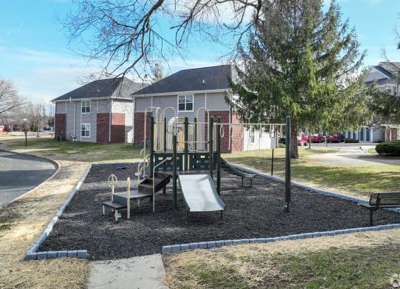 a playground in a park in front of a house