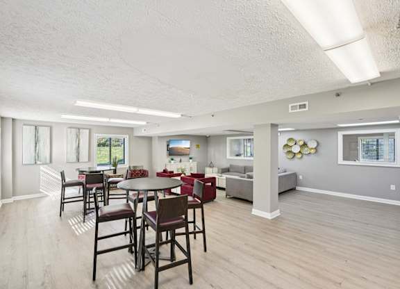 A dining room with a table and chairs.