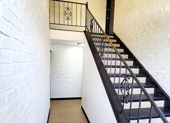 A long hallway with a staircase on the right side.