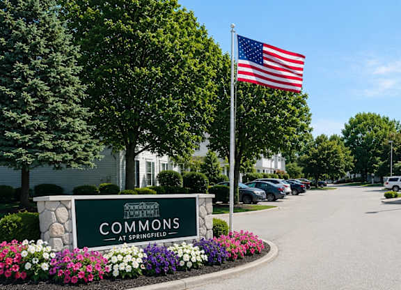 The entrance to a building with the sign "Commons" in front of it.