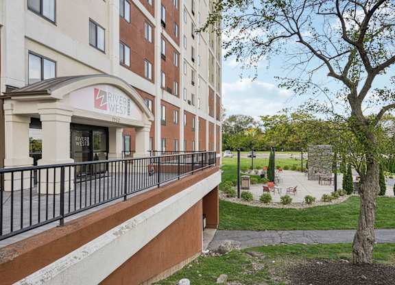 A building with a red and white sign that says "River West".