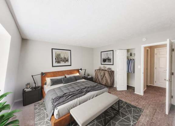 Carpeted bedroom with a closet, a bed in the middle, and a dresser. 