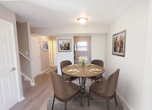 a dining room with a table and chairs