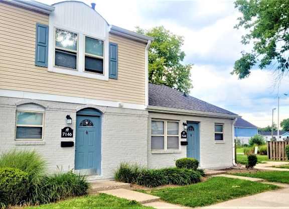 Exterior of townhomes in Indianapolis, IN with small front yards and sidewalks. 