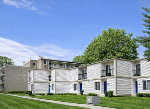 Apartment building with blue doors and windows.