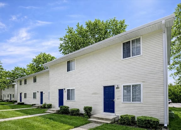 A white house with blue doors and windows.