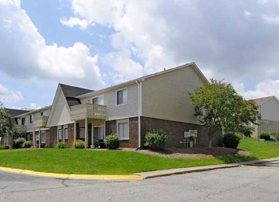 Exterior of Fox Club apartment buildings with large grassy yards.