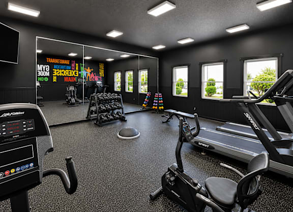 A gym with a treadmill, exercise bike, and other equipment.