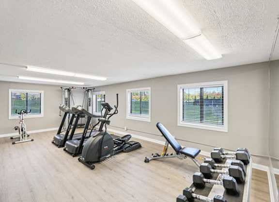 A spacious home gym with a variety of exercise equipment.