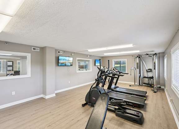 A spacious room with treadmills and exercise equipment.