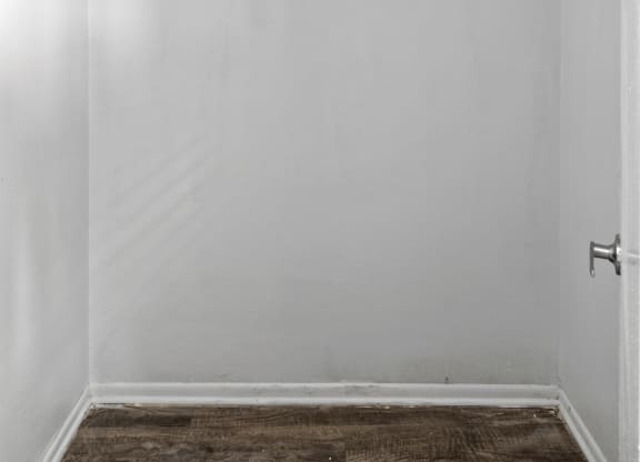 an empty room with white walls and a white door