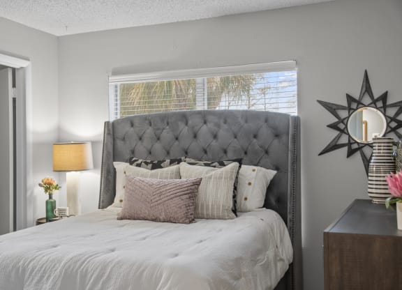 a bedroom with a large bed and a window