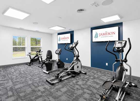 A gym with exercise equipment and a sign that says