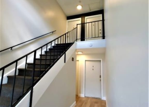 Interior of The Hub at Nora apartment building with black stairs. 