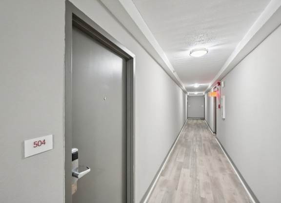 A hallway with a door numbered 504.