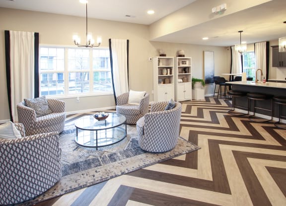 a living room with chairs and a table