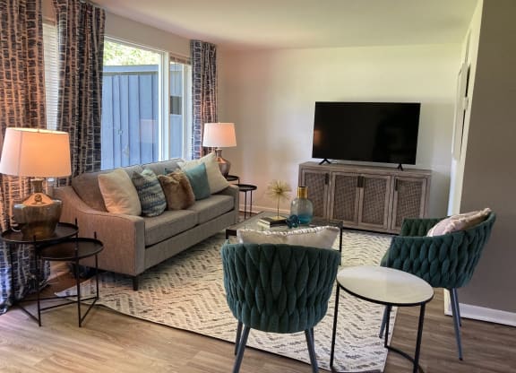 a living room with a couch and a tv at Townhomes at 28th, Columbus, Indiana