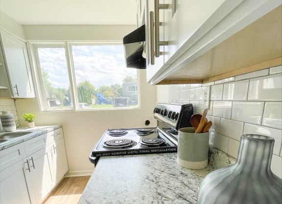 a kitchen with a marble counter top and a stove at Townhomes at 28th, Columbus, IN, 47201