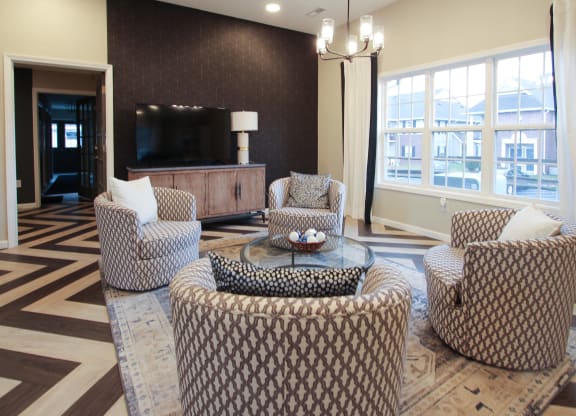 a living room with couches and chairs and a television