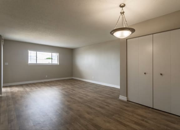 A room with a wooden floor and a window.