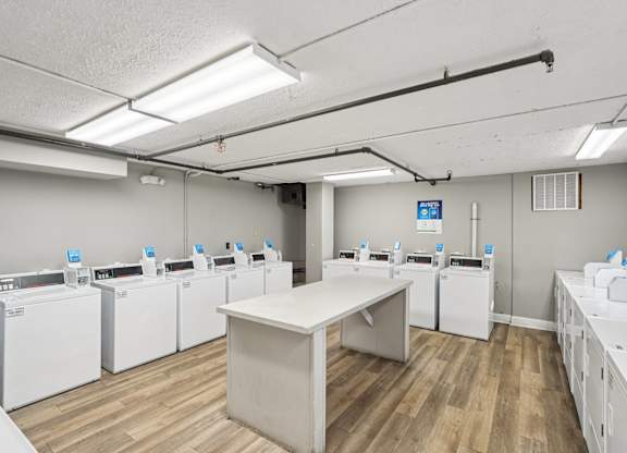 A laundromat with rows of washers and dryers.