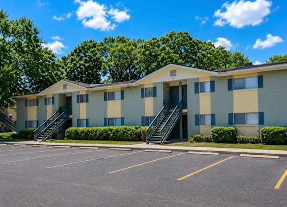 A large building with a parking lot in front of it.
