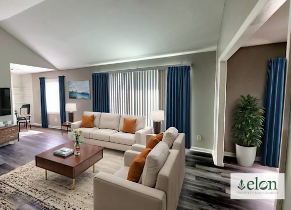 A living room with a white couch and a coffee table.
