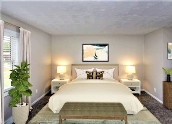Carpeted bedroom with a bed in between two night stands and a window.  