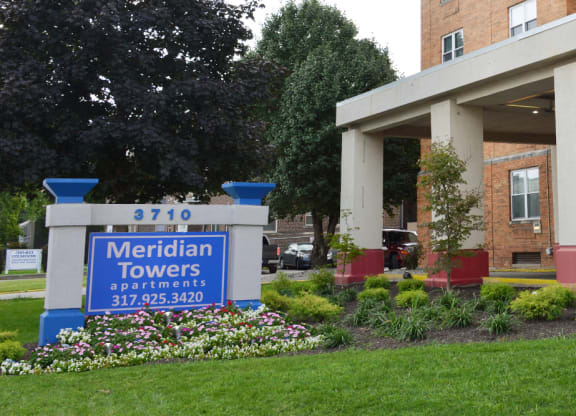 the front of a building with a sign for meridian towers apartments