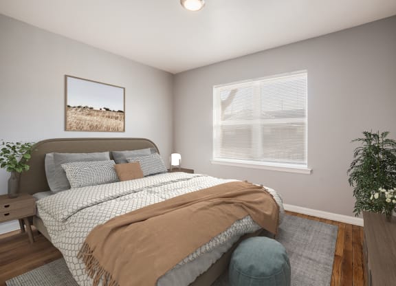 a bedroom with a bed and a chair and a window