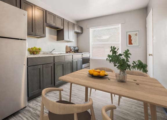 a kitchen with stainless steel appliances and a table with fruit