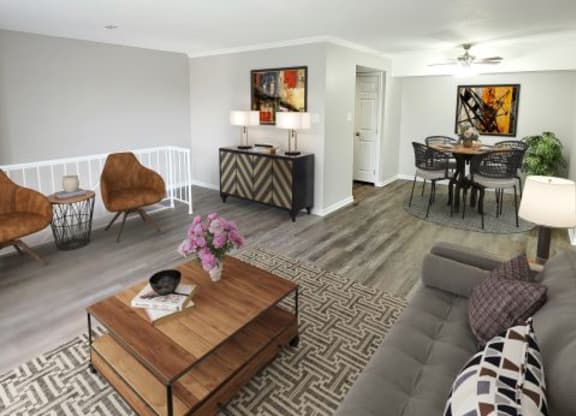 Spacious living room next to the dining area and the stairs leading to the bottom level. 