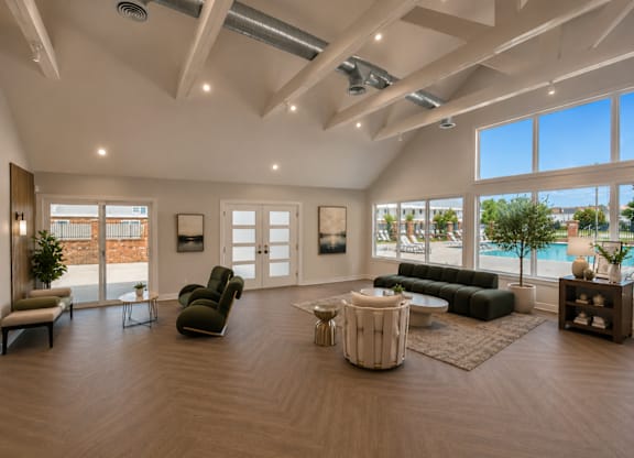 A spacious living room with a large window and a view of the backyard.
