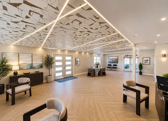 A modern living room with a wooden floor and a ceiling with a unique design.