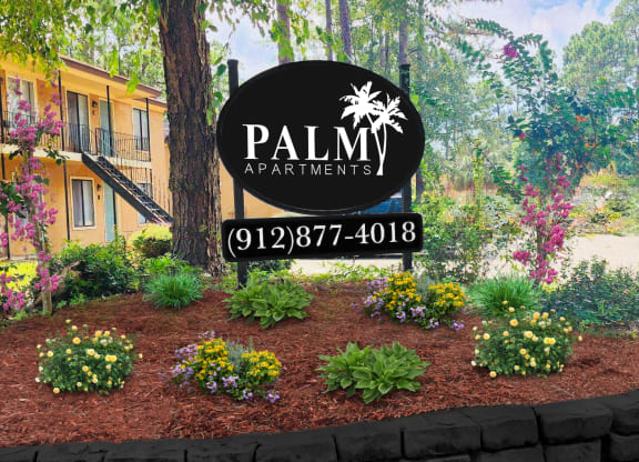 a picture of a garden with a sign that says palm apartments