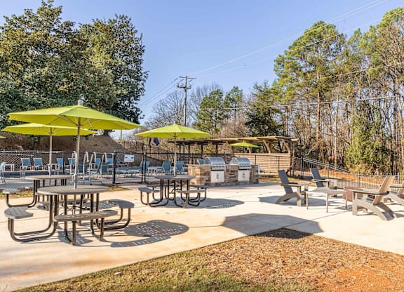 A sunny day at the outdoor picnic area with tables and chairs.