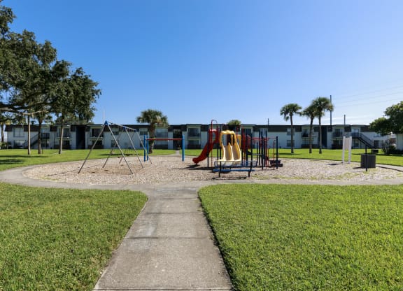 a playground in a park in front of a building